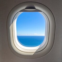 View of a bright blue sky and ocean, seen from an airplane window