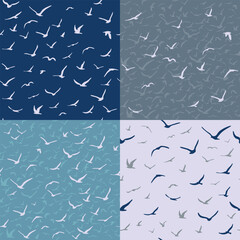A collection of seamless bird patterns. A flock of flying silhouette birds. Set. White seagulls on a blue