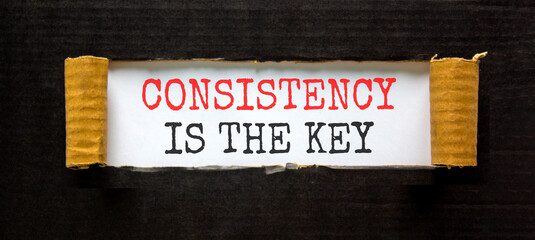 Consistency is the key symbol. Concept words Consistency is the key on beautiful white paper. Beautiful black paper background. Business consistency is the key concept. Copy space.