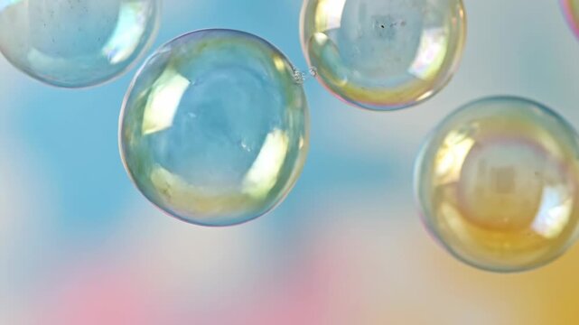 Shiny transparent soap bubbles and liquid glass spheres float as 3d crystal globes with reflections against a bright blue sky background