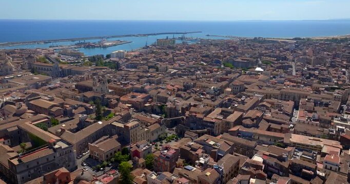 Aerial view of the city of Catania, Sicily, Italy. In foreground c' &egrave; la Saint Francis of Assisi all'Immacolata Church. In the background, the city port and the Mediterranean Sea on the horizon.
