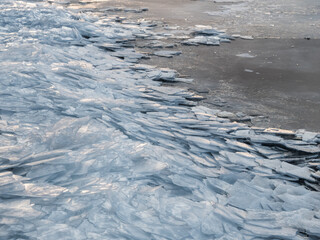 Layers of cracked ice on lakeside