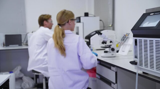 Scientists conduct research in laboratory space during daytime hours