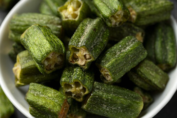 Crispy okra chips in a white bowl. Healthy snack