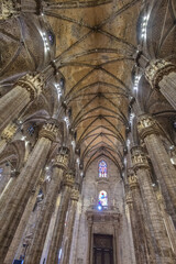 Fototapeta premium Milan Gothic Cathedral Interior With Ornate Vaulted Ceiling And Massive Stone Columns