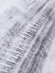 Tire tracks on the snow-covered road.