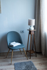 Cozy armchair with folded blanket in modern minimalist living room