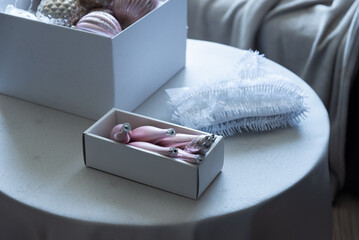 Christmas ornaments in storage box on round table in modern living room