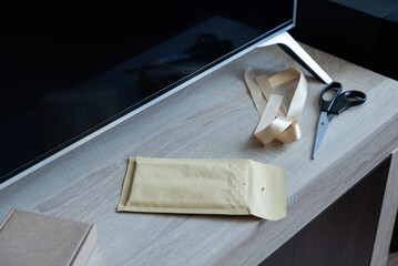 Padded envelope and packing tools on modern work desk