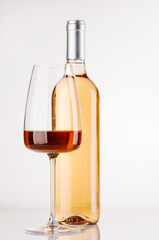 Rose wine bottle and glass on white background