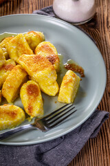 Homemade lazy noodles with cheese, crumbs and melted butter.