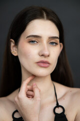 Natural emotional portrait of young woman model with expressive face, authentic beauty, lifestyle mood, clean skin, real emotions, modern female portrait photography in studio