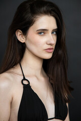 Young brunette woman studio portrait with natural beauty and emotional expressions, close up face, healthy skin, minimal fashion style, modern people and lifestyle concept