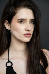 Natural emotional portrait of young woman model with expressive face, authentic beauty, lifestyle mood, clean skin, real emotions, modern female portrait photography in studio