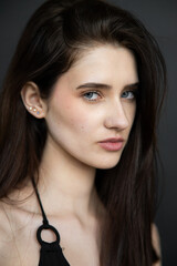 Young brunette woman studio portrait with natural beauty and emotional expressions, close up face, healthy skin, minimal fashion style, modern people and lifestyle concept