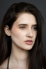 Natural emotional portrait of young woman model with expressive face, authentic beauty, lifestyle mood, clean skin, real emotions, modern female portrait photography in studio