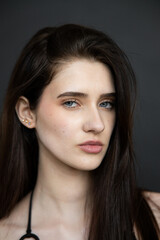 Fototapeta premium Young beautiful fashion model woman posing in studio, natural beauty, clean skin, professional modeling portfolio, elegant female portrait, modern style, confident look, people concept photography