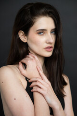 Natural emotional portrait of young woman model with expressive face, authentic beauty, lifestyle mood, clean skin, real emotions, modern female portrait photography in studio