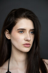 Natural emotional portrait of young woman model with expressive face, authentic beauty, lifestyle mood, clean skin, real emotions, modern female portrait photography in studio