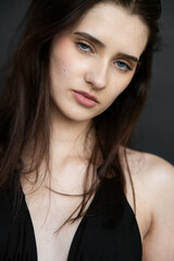 Natural emotional portrait of young woman model with expressive face, authentic beauty, lifestyle mood, clean skin, real emotions, modern female portrait photography in studio