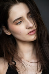 Natural emotional portrait of young woman model with expressive face, authentic beauty, lifestyle mood, clean skin, real emotions, modern female portrait photography in studio