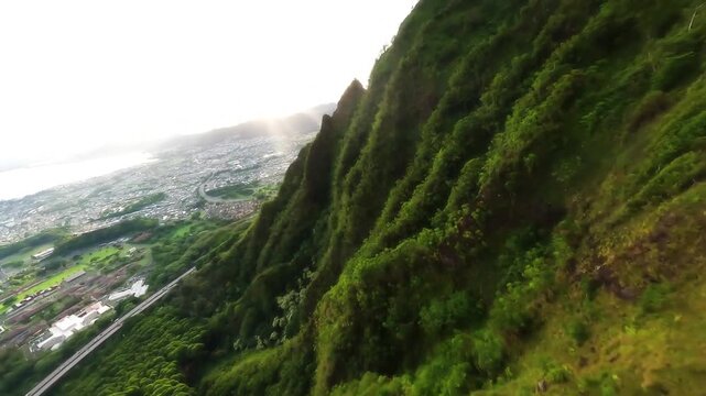 FPV drone flight along a Hawaiian mountain ridge at snset.
