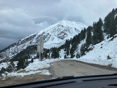 Road winding through snowy Pyrenees mountains in Spain