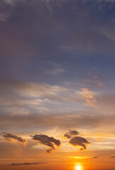 Beautiful multi-colored sunset with clouds as the sun sets over the horizon, multi-colored sky with warm colors and a touch of sunset or sunrise