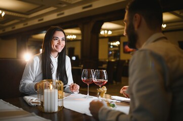 Happy couple enjoying romantic dinner date at restaurant