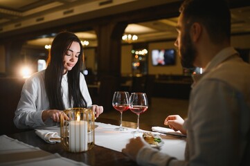 Couple enjoying romantic dinner at elegant restaurant