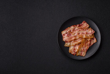 Fried smoked bacon slices, ham, jamon, or prosciutto strips for cooking. Fried bacon