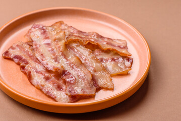 Fried smoked bacon slices, ham, jamon, or prosciutto strips for cooking. Fried bacon