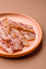 Fried smoked bacon slices, ham, jamon, or prosciutto strips for cooking. Fried bacon