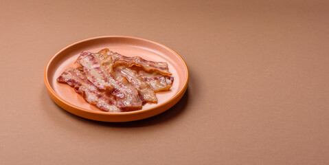 Fried smoked bacon slices, ham, jamon, or prosciutto strips for cooking. Fried bacon