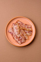 Fried smoked bacon slices, ham, jamon, or prosciutto strips for cooking. Fried bacon