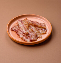 Fried smoked bacon slices, ham, jamon, or prosciutto strips for cooking. Fried bacon