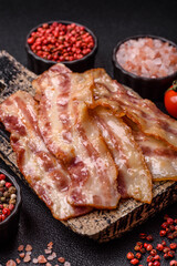 Fried smoked bacon slices, ham, jamon, or prosciutto strips for cooking. Fried bacon