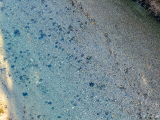 Aerial View Of Clear Turquoise River Winding Through Rocky Shallows In British Columbia