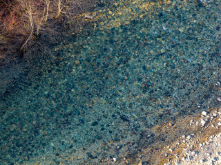 Aerial View Of Clear Turquoise River Winding Through Rocky Shallows In British Columbia