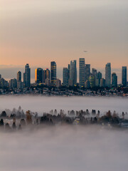 Golden Sunrise Over Downtown Skyline Shrouded in Fog in Burnaby, British Columbia