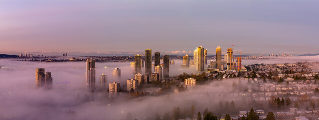 Sunrise Over Foggy Downtown Burnaby From A Panoramic Cityscape Above Suburban Homes At Dawn