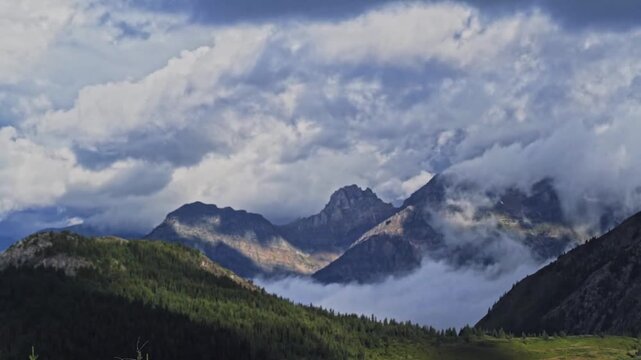 Majestic Mountain Peaks Peeking Through Thick White Couds