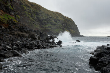 Narrow volcanic inlet with rough Atlantic waves, Azores