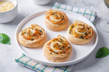 Basil garlic cheese roll cake pinwheel in a plate on a white isolated background