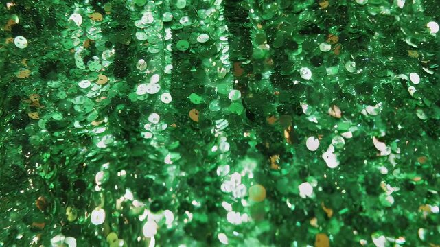 Bright green glitter sequins create a dazzling textured background suitable for holiday-themed projects. the sparkling surface is ideal for christmas decorations, creative crafts, and design elements 
