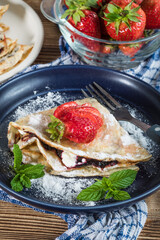 Polish pancakes with jam, cheese and strawberries.