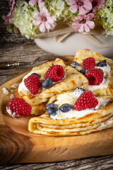 Pancakes with white cheese and fruit.