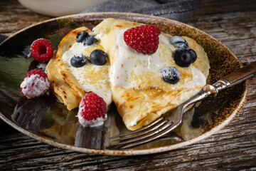 Pancakes with white cheese and fruit.