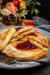 Crepes with cheese and blackcurrant jam.