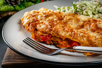 Stuffed pancake baked with cheese.